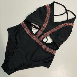 Women’s one piece Black with ornate ribbon.